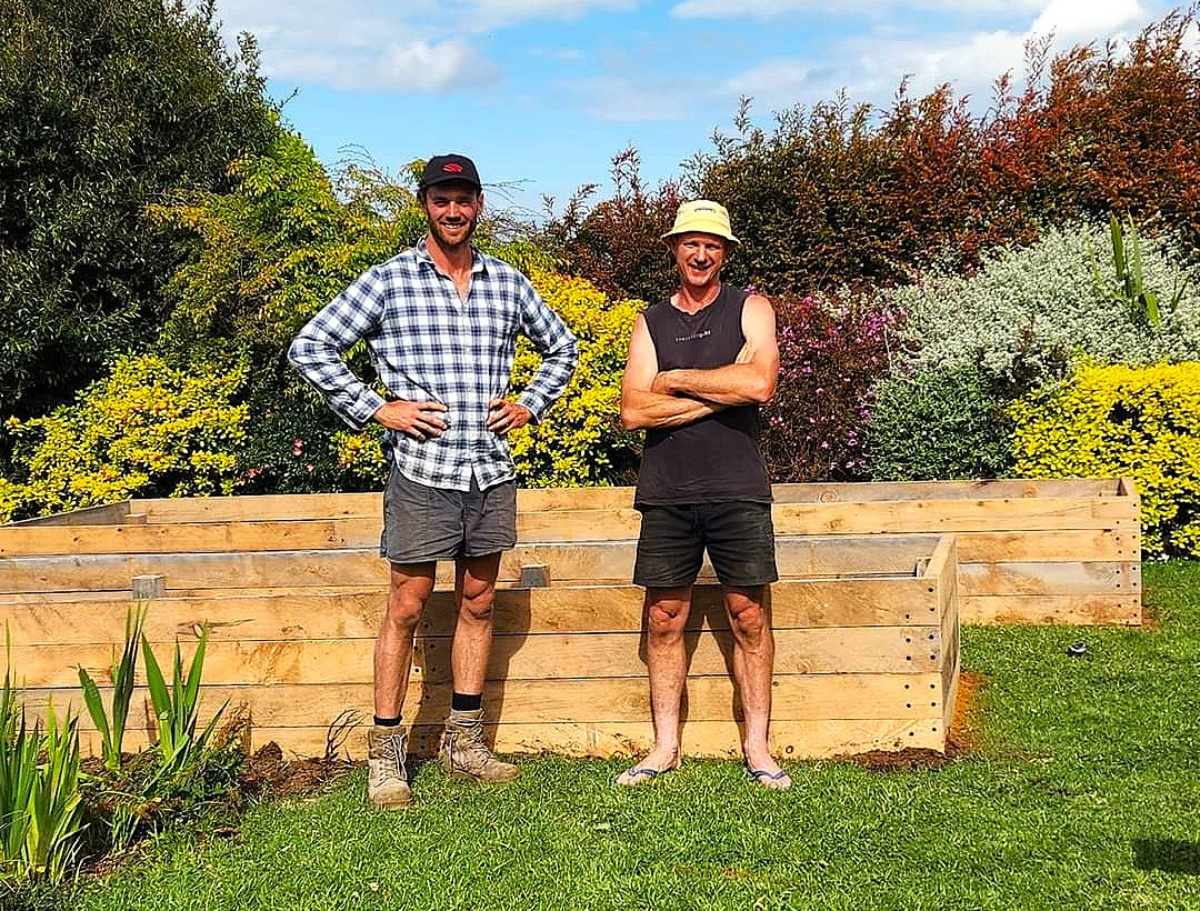 Lets Grow Home team standing beside timber beds thumbnail